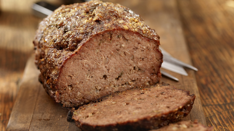 Cooked meatloaf sliced on a board