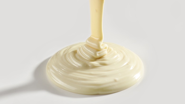 Pouring melted white chocolate into a pile