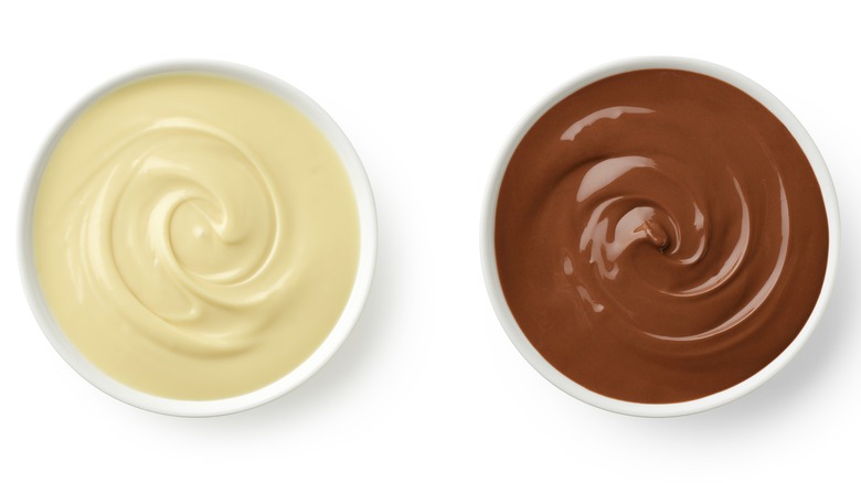 Bowl of melted white chocolate next to a bowl of melted milk chocolate