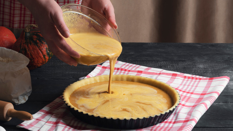 pouring pie filling into crust