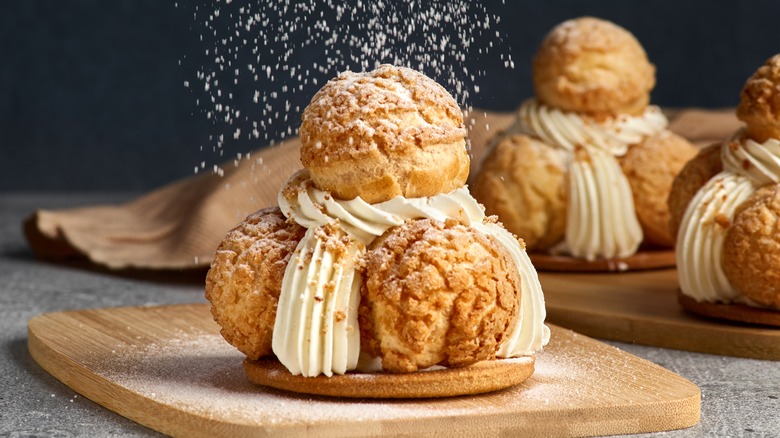 Cream puffs with custard and powdered sugar 