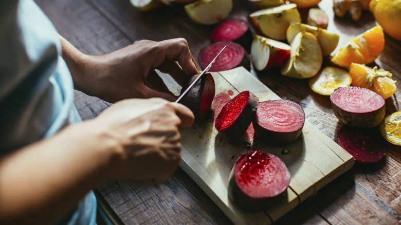 person slicing beets