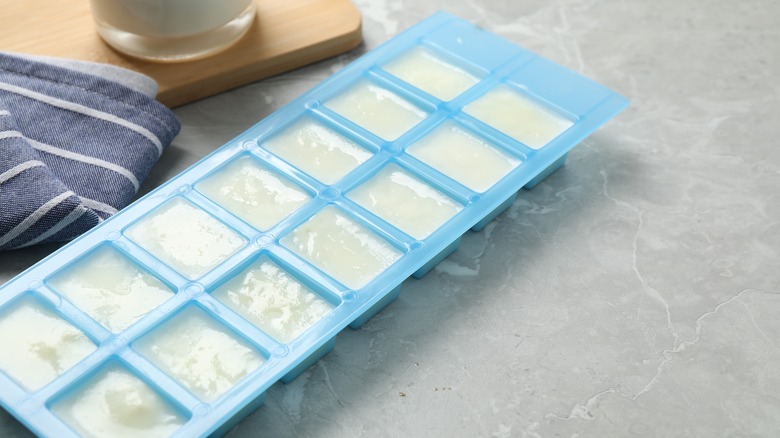 Silicone ice cube tray with frozen milk cubes