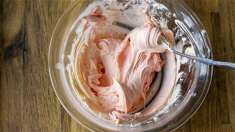 Pink frosting in clear bowl 