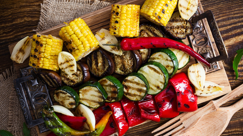 Variety of grilled veggies on wood platter