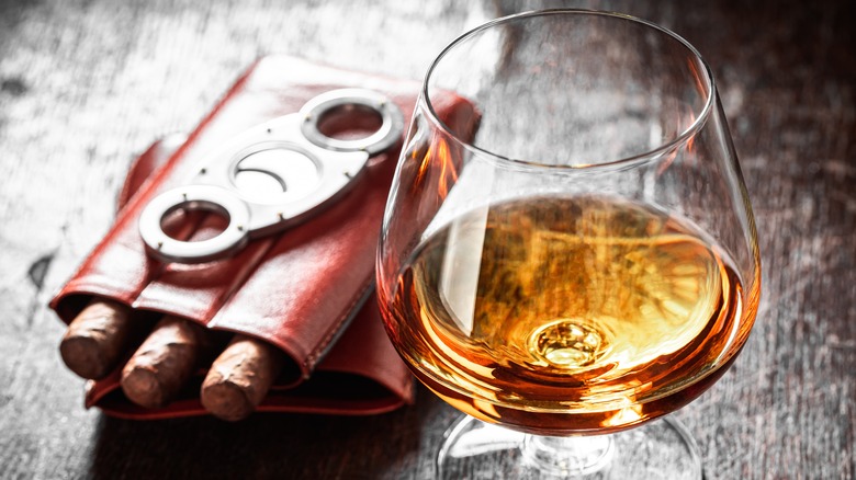 glass of whiskey with cigars