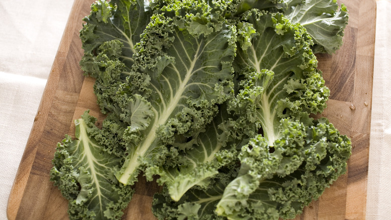 Stemmed kale on chopping board