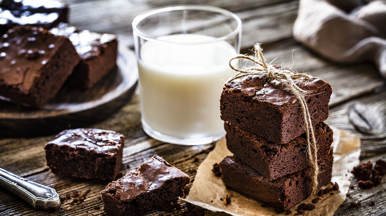 Glass of milk by brownie stacks