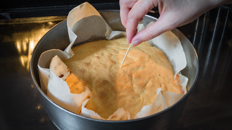 Testing a cake with a toothpick