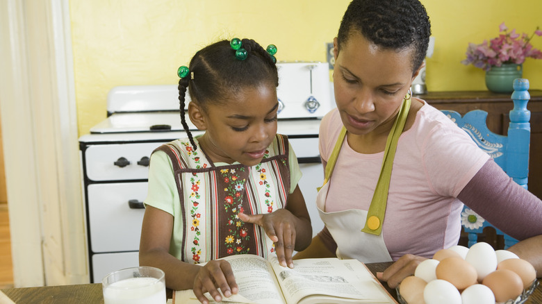 Mother and daughter looking at a recipe