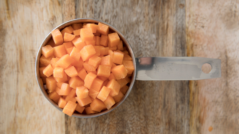 Diced carrots in a measuring cup