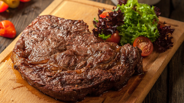 Grilled steak on wooden board