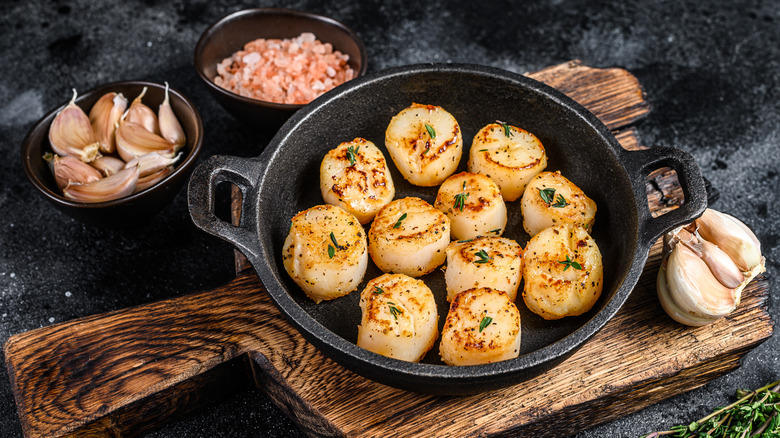 Fried scallops in cast iron pan 