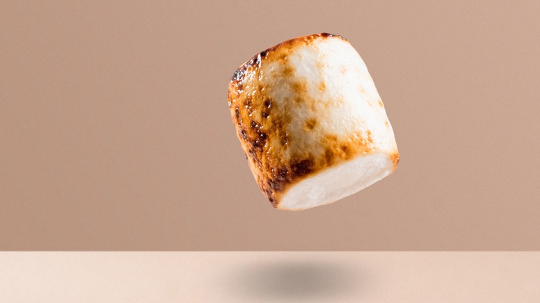 Toasted marshmallow hovering over table