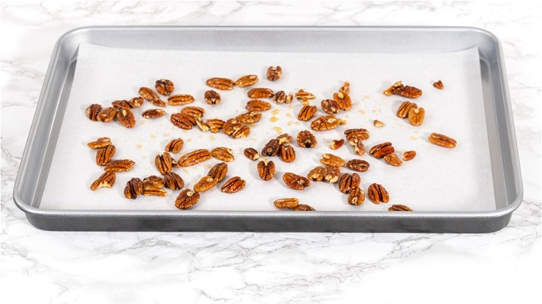 Pecans on parchment lined baking sheet