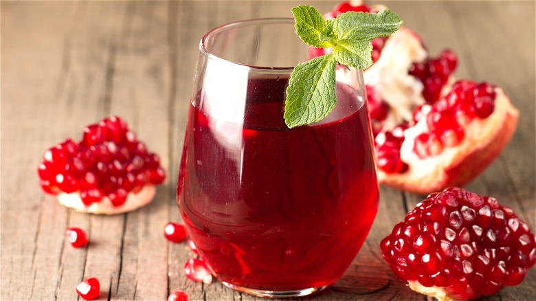 Pomegranate juice in glass with fruit 