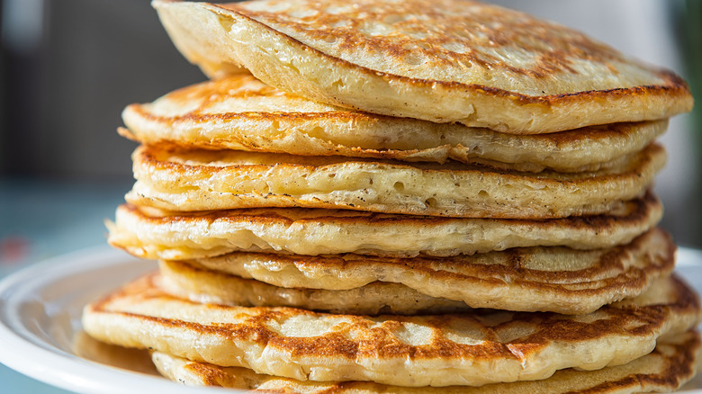 A stack of plain pancakes on plate