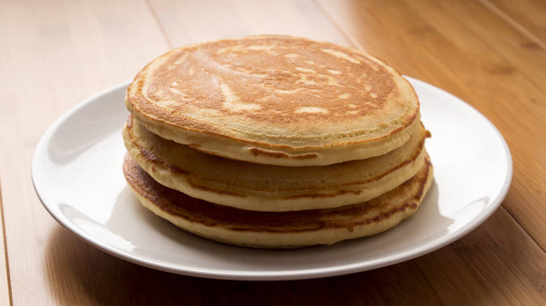 A stack of plain pancakes on plate