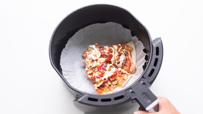 Pizza slices in air fryer basket