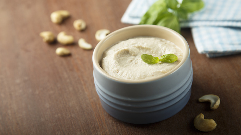 Vegan cashew cream cheese in a white bowl with herbs