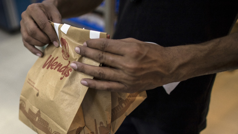 Wendy's employee with food bag