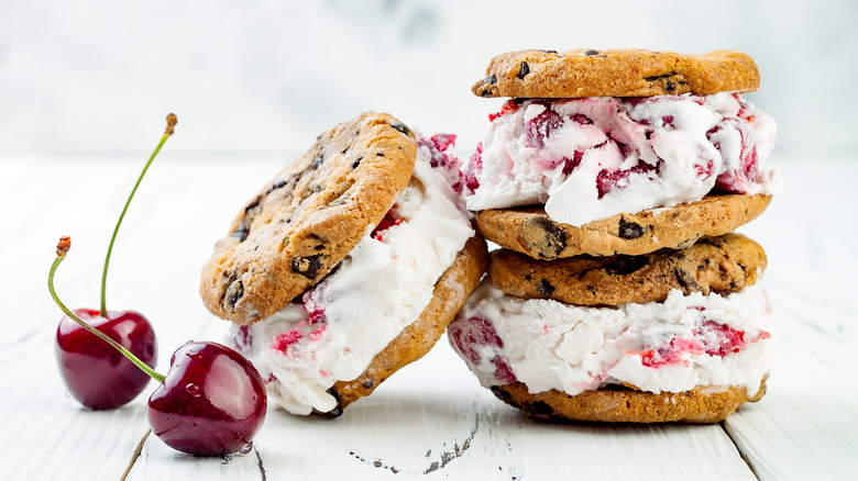 Cherry ice cream sandwiched between two chocolate chip cookies