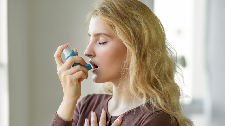 woman using inhaler