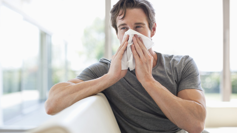 man blowing nose