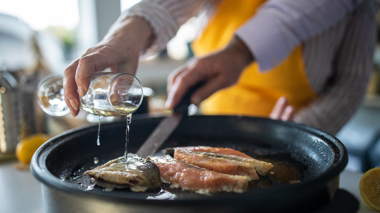 couple making salmon with white wine