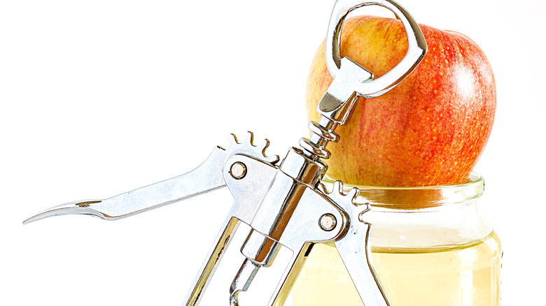 Apple and corkscrew on jar