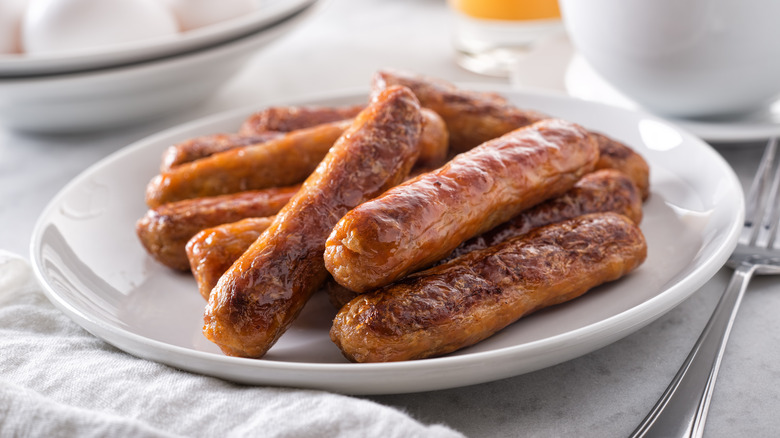Breakfast sausage links on a white plate