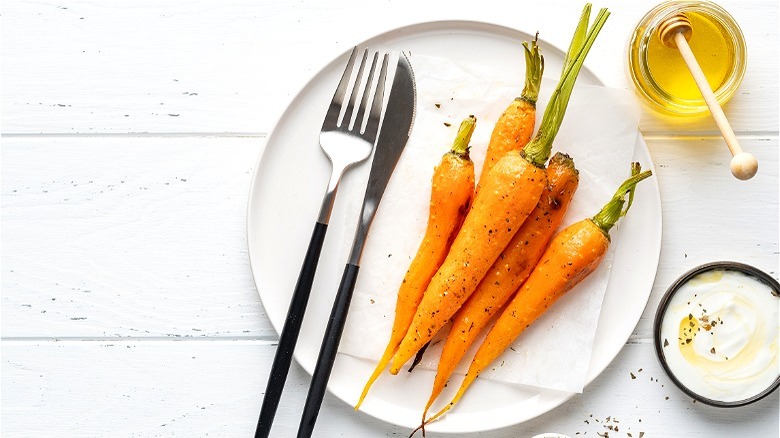 cooked carrots on white plate 