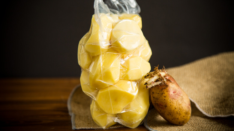 vacuum-sealed bag of potatoes with whole potato