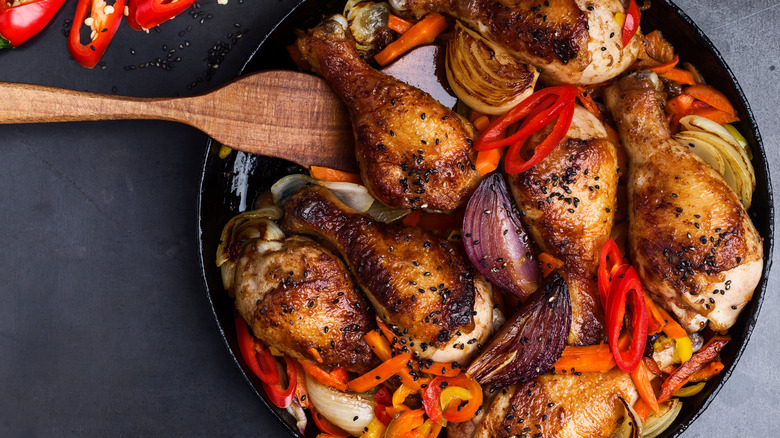 browned chicken cooking in pan