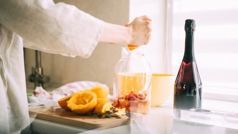 hand preparing punch in jug