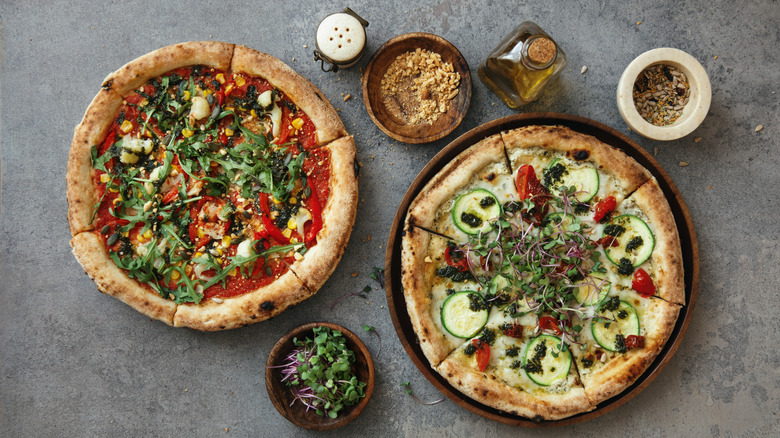 Cheeseless pizzas topped with veggies