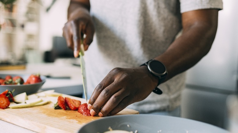 man cutting strawberries 