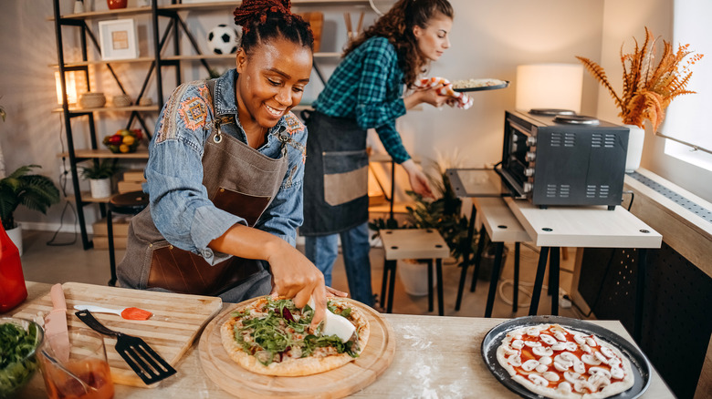 people making pizza at home