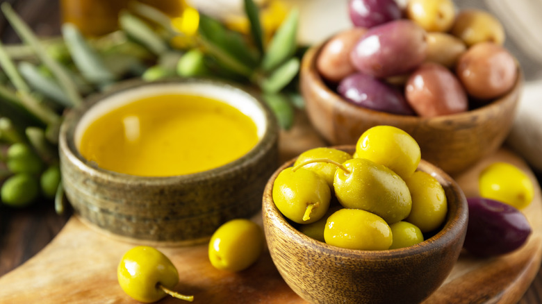 Olive oil and olives in dishes