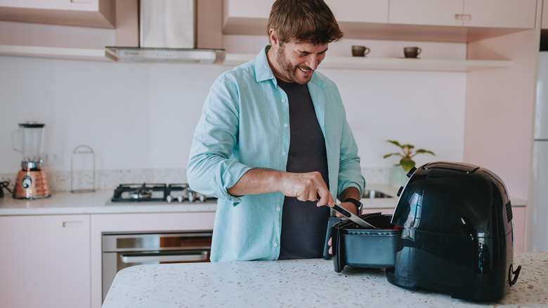 man using air fryer