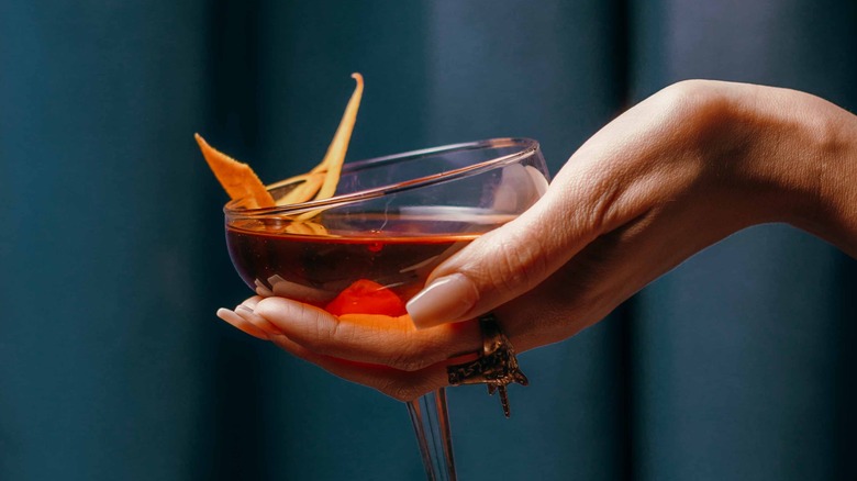 Person holding cocktail in coupe