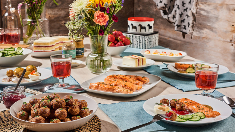 Table spread of food, drinks, and flowers