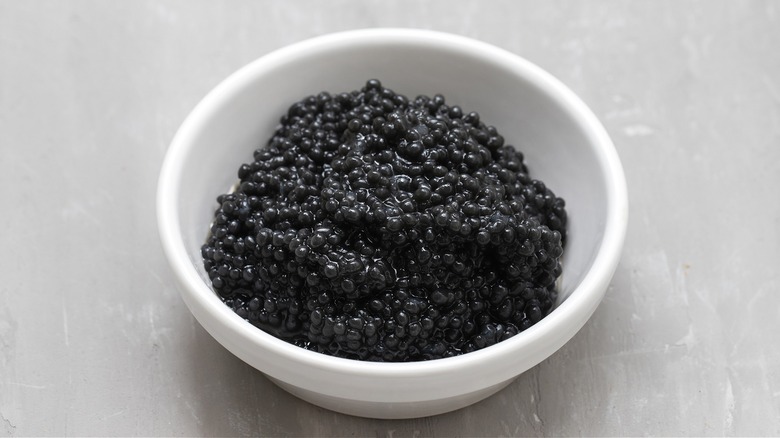 white bowl of black caviar