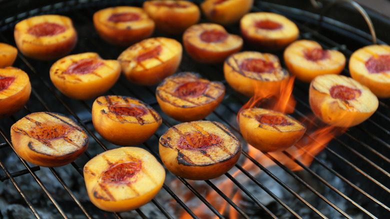 Peaches sit on the grill