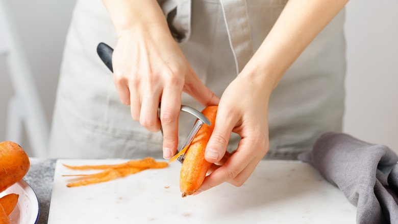 Peeling carrots with vegetable peeler