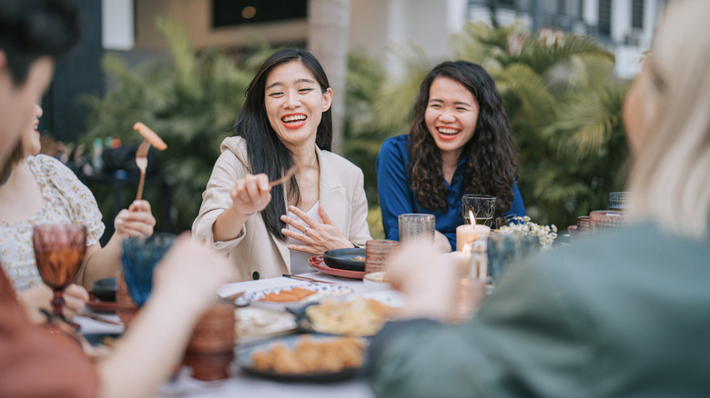 Friends laughing at dinner party