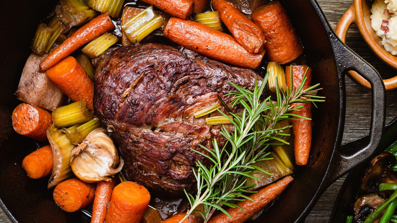 close-up overhead shot of homemade pot roast in a cast iron Dutch oven