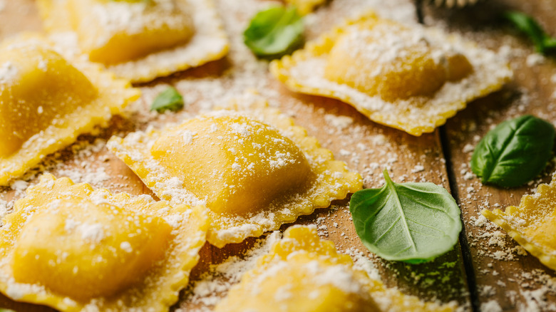 Fresh ravioli on wood board