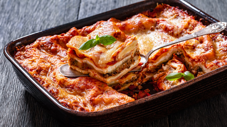 Slice of lasagna being lifted out of a tray