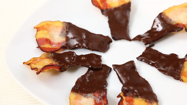 Circle of chocolate covered bacon on plate